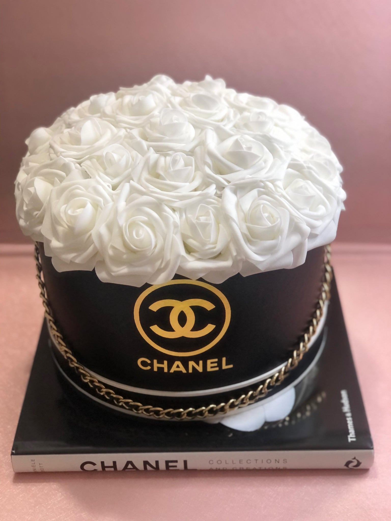 Premium AI Image  A woman holds a box of flowers that says chanel on it.